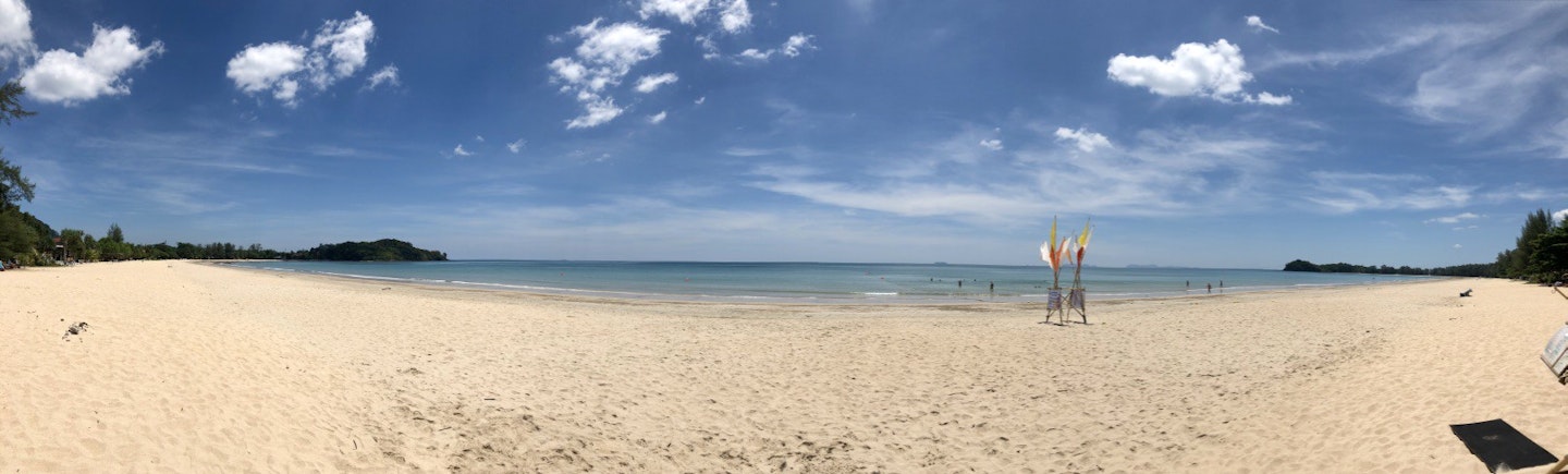 panorama with white sand, blue sky and the ocean on Ko Lanta, Thailand